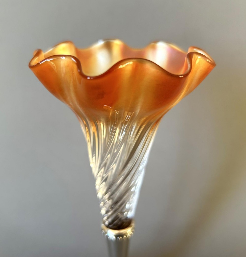 An Edwardian posy vase featuring a wrythen glass trumpet with a flared orange rim, set into a silver pedestal base. View VII