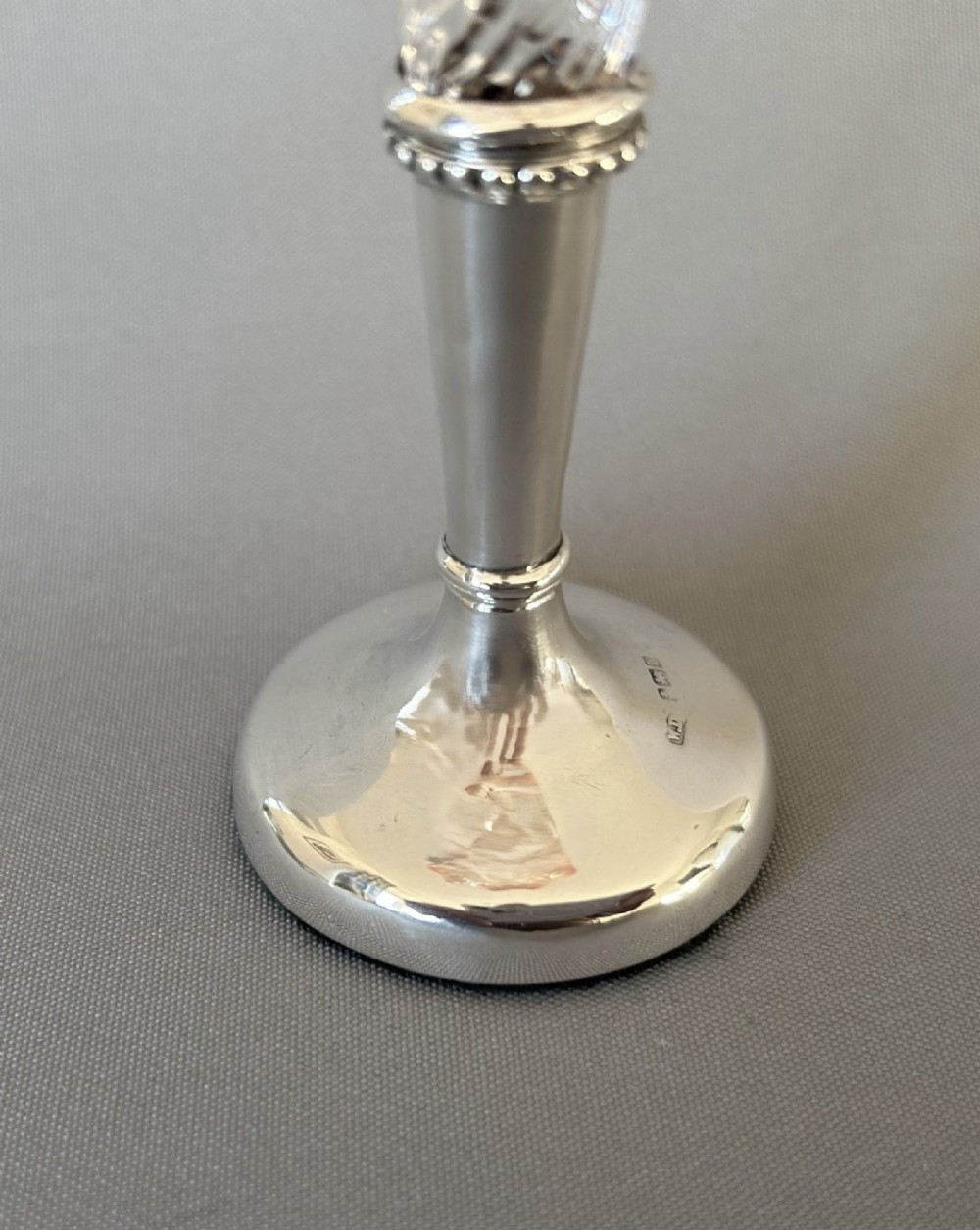 An Edwardian posy vase featuring a wrythen glass trumpet with a flared orange rim, set into a silver pedestal base. View VIII