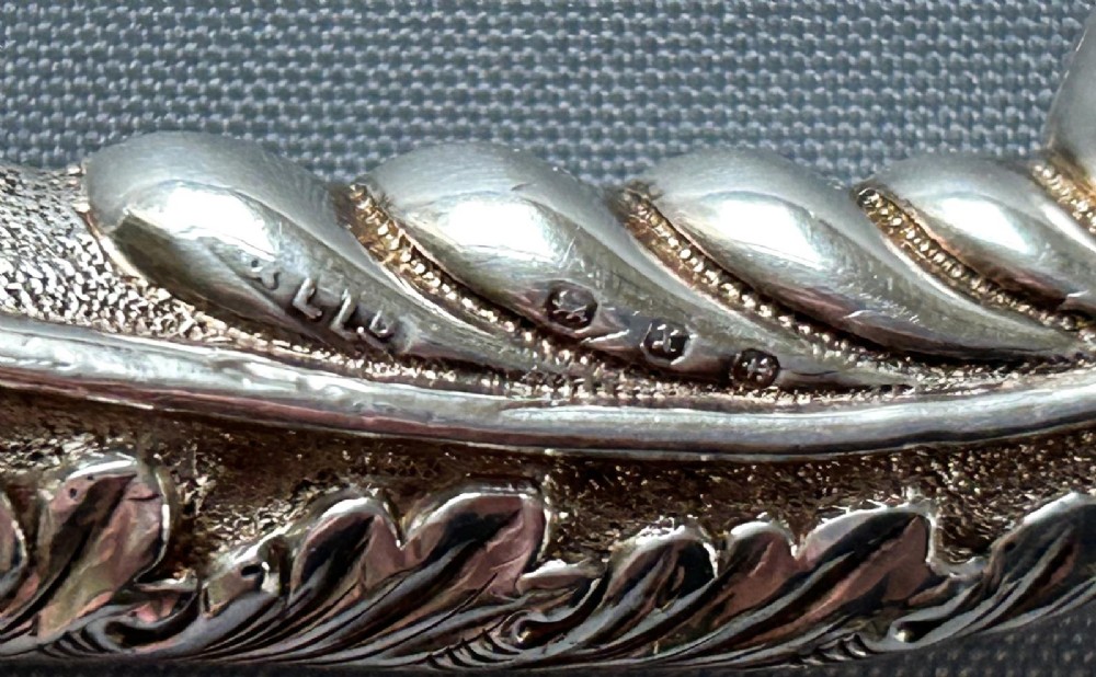 A Victorian silver toasting fork featuring a three-tined head with a pierced trefoil design, a slender stem, and a handle sculpted as a panther head. View III
