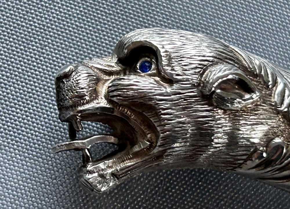 A Victorian silver toasting fork featuring a three-tined head with a pierced trefoil design, a slender stem, and a handle sculpted as a panther head. View VII
