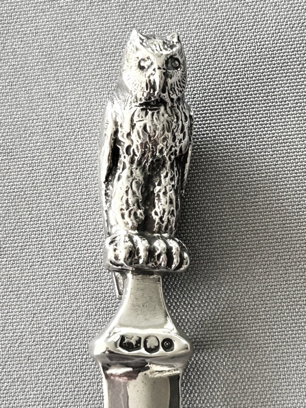 A silver letter opener featuring a finely cast owl handle above a polished blade engraved with script text. View III