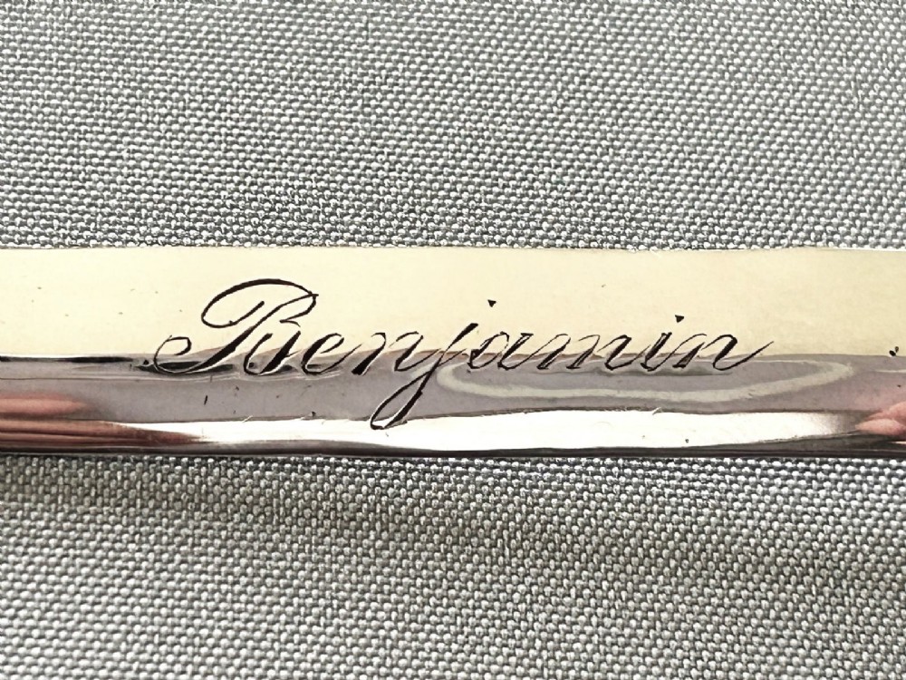 A silver letter opener featuring a finely cast owl handle above a polished blade engraved with script text. View VI