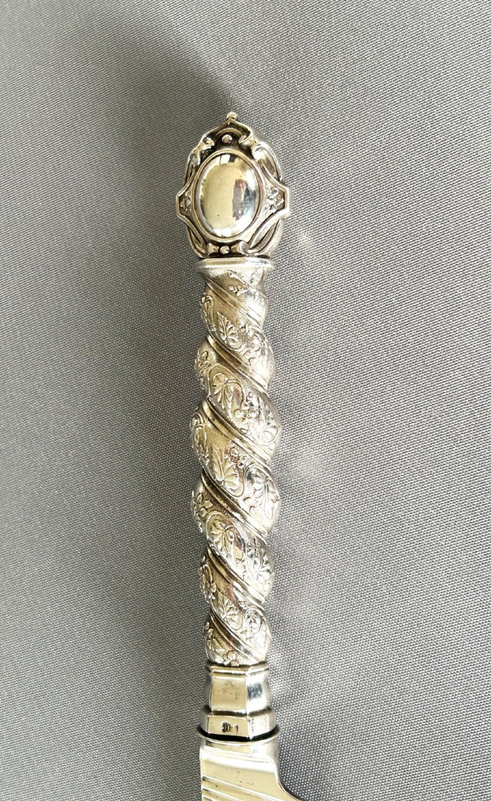 A Victorian silver fish serving knife featuring an engraved river landscape scene on the blade and a chased spiral twist handle. View IV