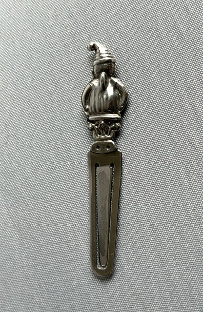 A solid silver bookmark featuring a cast figural handle of Mr. Punch above a flat clip section stamped with Scottish hallmarks. View IV