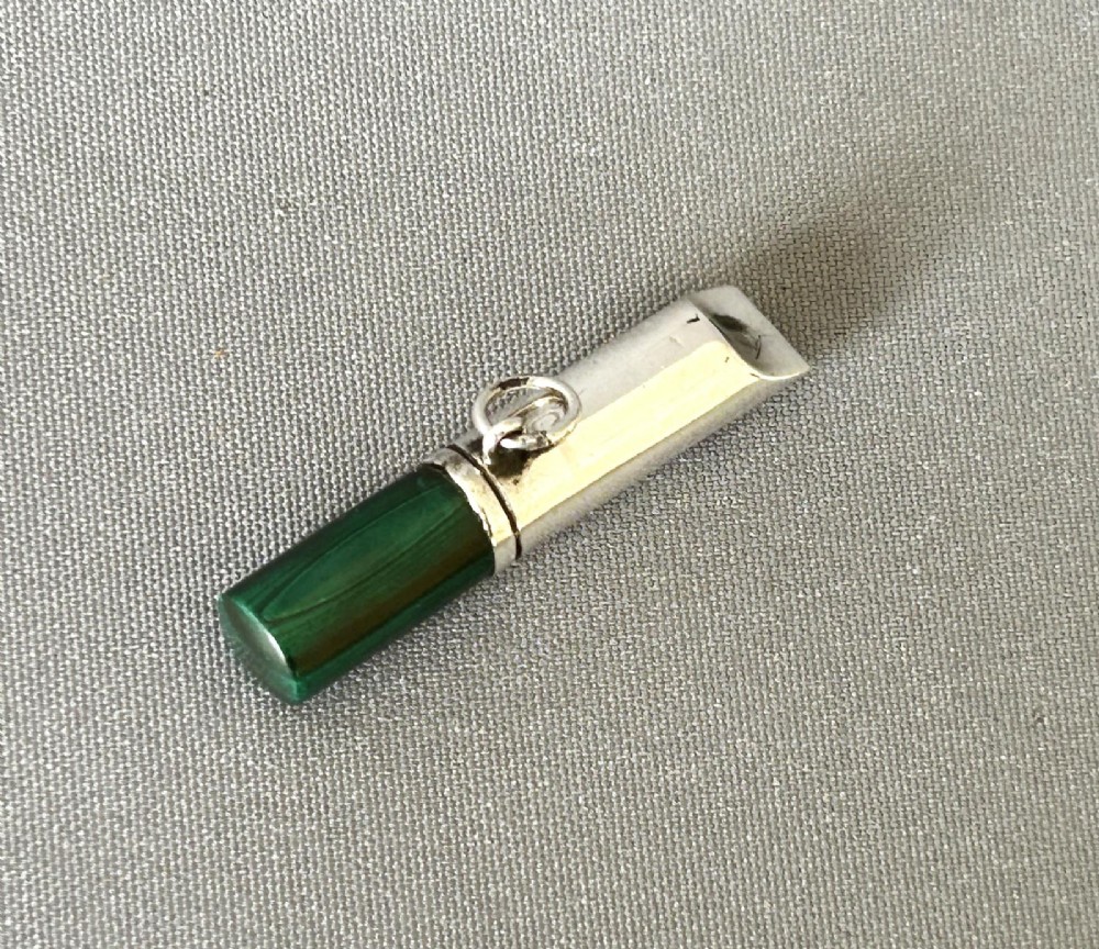 A Victorian silver whistle with a cylindrical polished green malachite handle and a silver suspension ring. View II