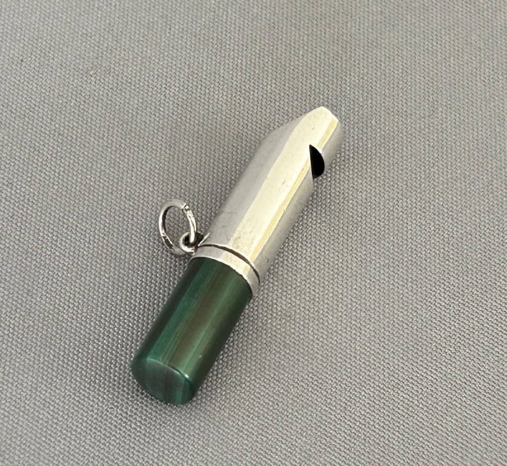 A Victorian silver whistle with a cylindrical polished green malachite handle and a silver suspension ring. View III
