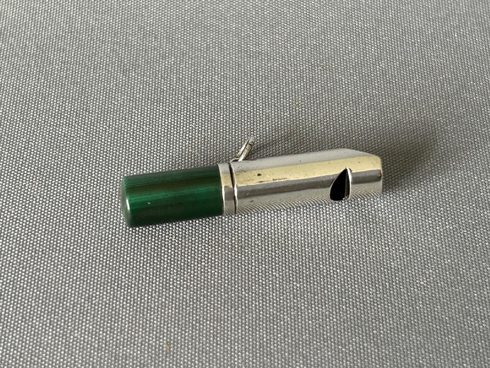 A Victorian silver whistle with a cylindrical polished green malachite handle and a silver suspension ring. View IV