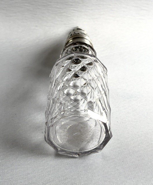 An 18th-century Georgian clear glass caster featuring diamond cut facets and a silver pierced cap with a finial. View III