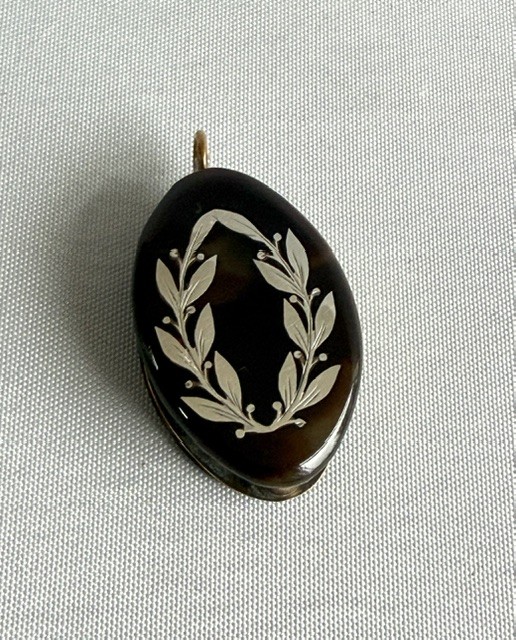 A Victorian oval dark brown tortoiseshell folding loupe decorated with silver pique foliate inlay and featuring a swivelling circular magnifying glass lens. View II