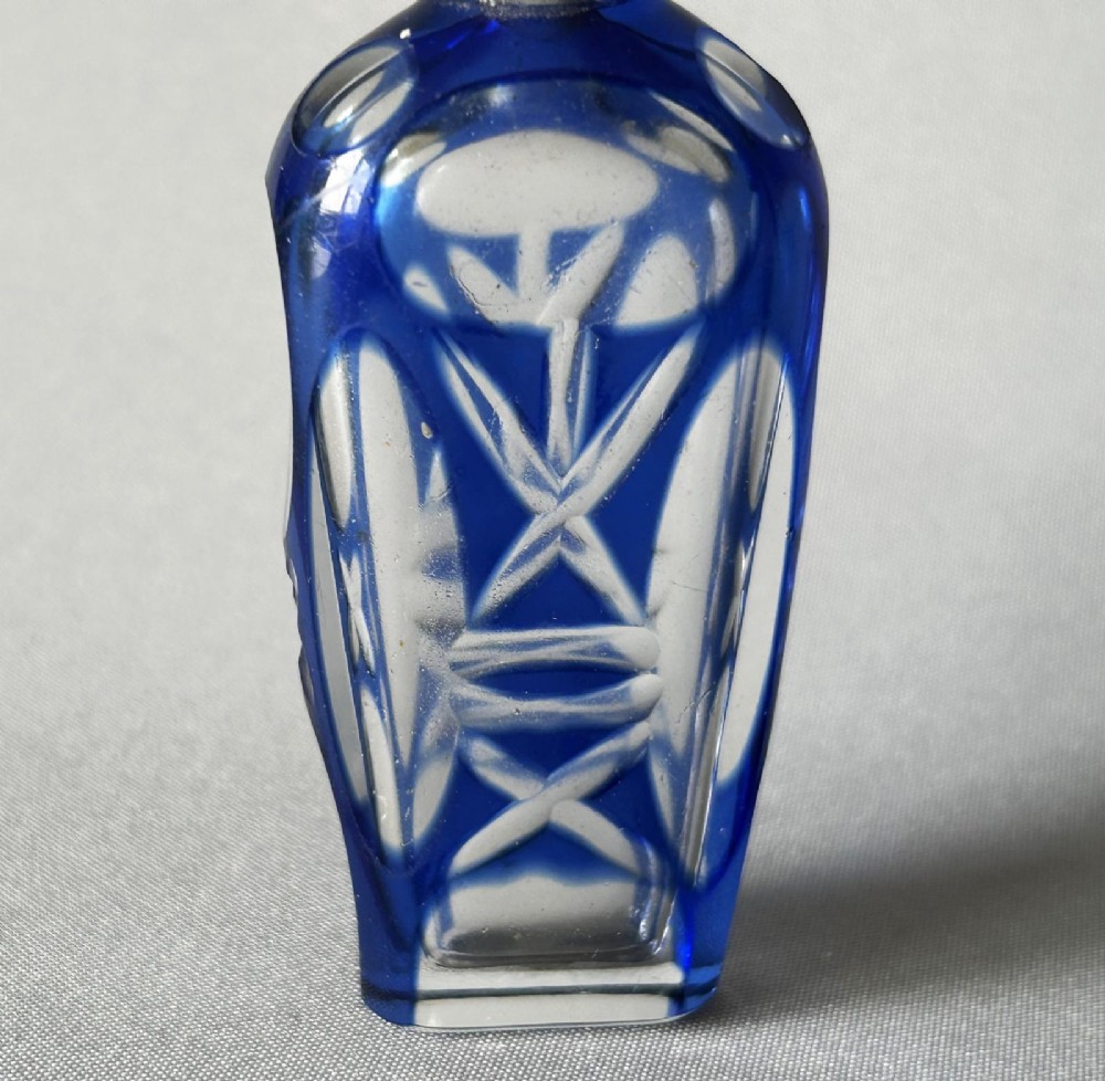 A Victorian cobalt blue cut-to-clear glass scent flask featuring a silver collar and a faceted clear glass stopper. View II