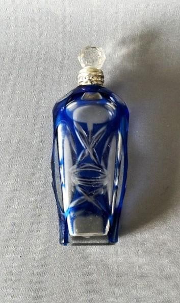 A Victorian cobalt blue cut-to-clear glass scent flask featuring a silver collar and a faceted clear glass stopper. View IV