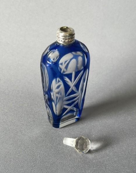 A Victorian cobalt blue cut-to-clear glass scent flask featuring a silver collar and a faceted clear glass stopper. View V