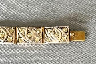 An Art Deco silver gilt panel link bracelet featuring geometric leaf motifs inlaid with small cut paste stones. View III