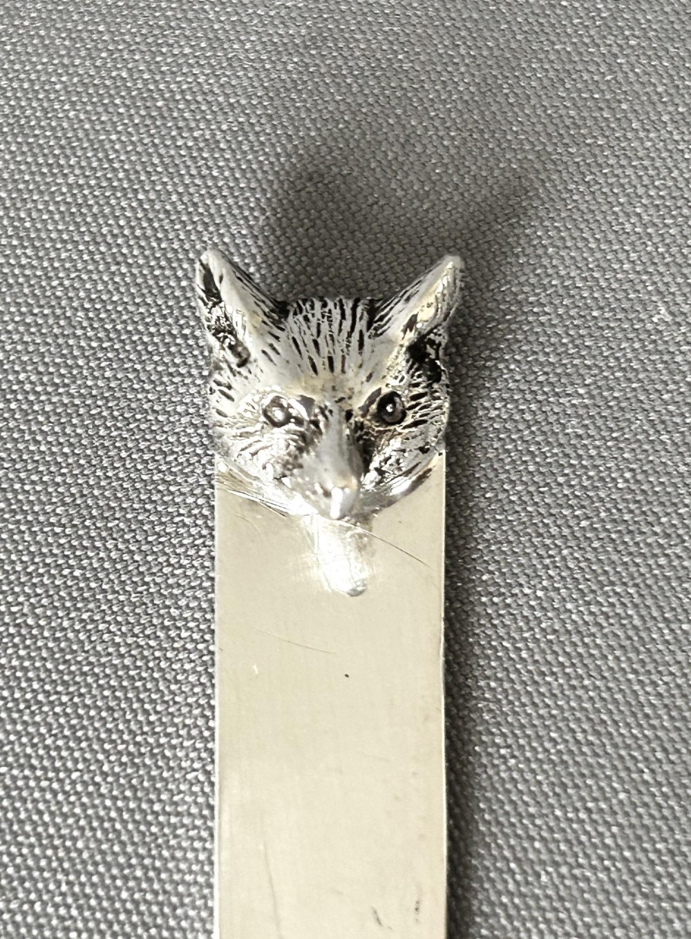 A silver letter opener featuring a tapered flat blade and a detailed cast fox head terminal. View IV
