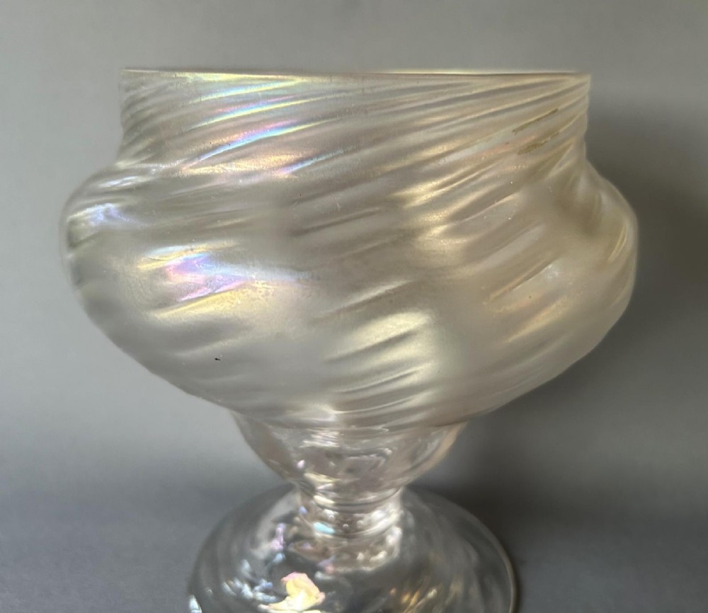 An Art Nouveau clear glass pedestal vase featuring a spiralled rib design and an iridescent lustre finish. View III