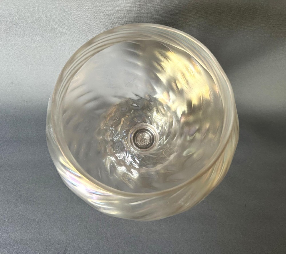 An Art Nouveau clear glass pedestal vase featuring a spiralled rib design and an iridescent lustre finish. View VI