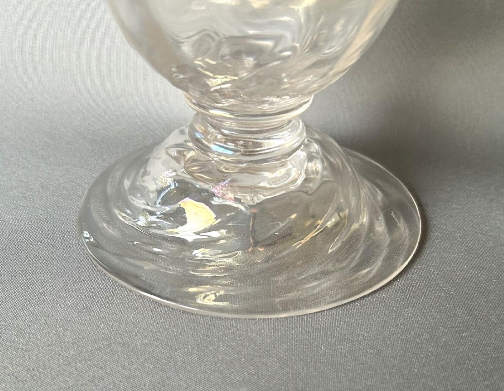 An Art Nouveau clear glass pedestal vase featuring a spiralled rib design and an iridescent lustre finish. View VIII