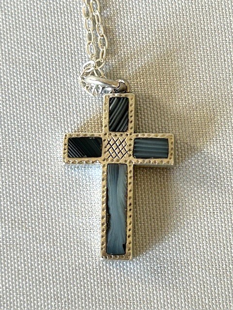 A Victorian silver cross pendant inlaid with grey and black striped Montrose agate panels, suspended on a fine silver link chain. View II