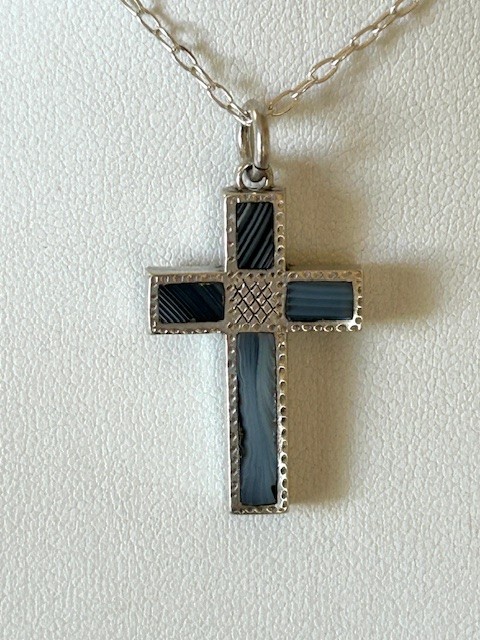 A Victorian silver cross pendant inlaid with grey and black striped Montrose agate panels, suspended on a fine silver link chain. View IV