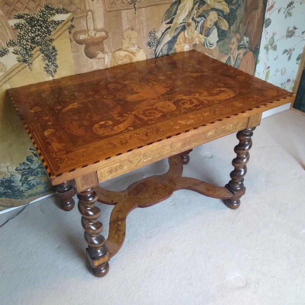 An 18th-century rectangular wooden centre table featuring elaborate floral marquetry inlay on the top, twisted legs, and a curvilinear X-frame stretcher. View II