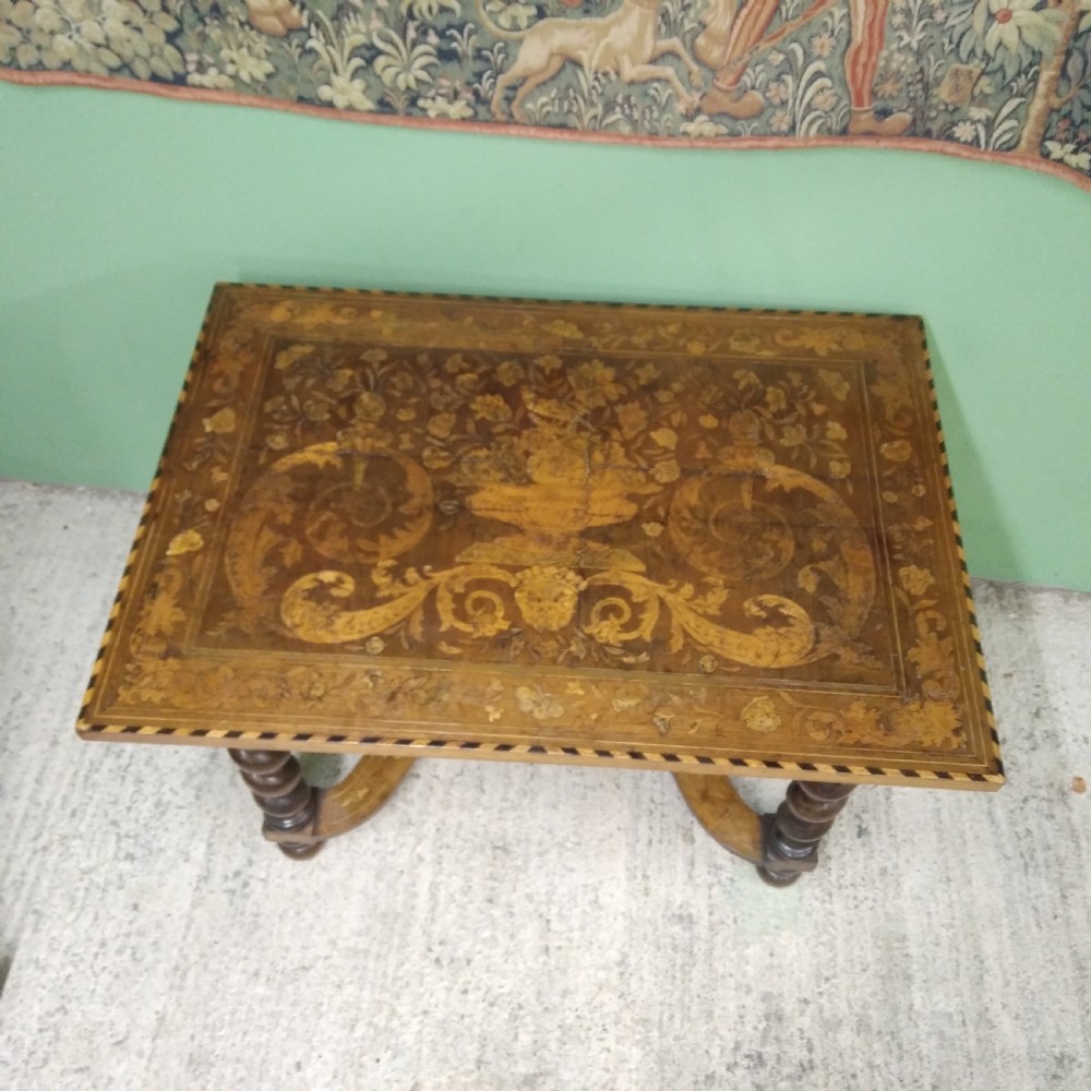 An 18th-century rectangular wooden centre table featuring elaborate floral marquetry inlay on the top, twisted legs, and a curvilinear X-frame stretcher. View VIII
