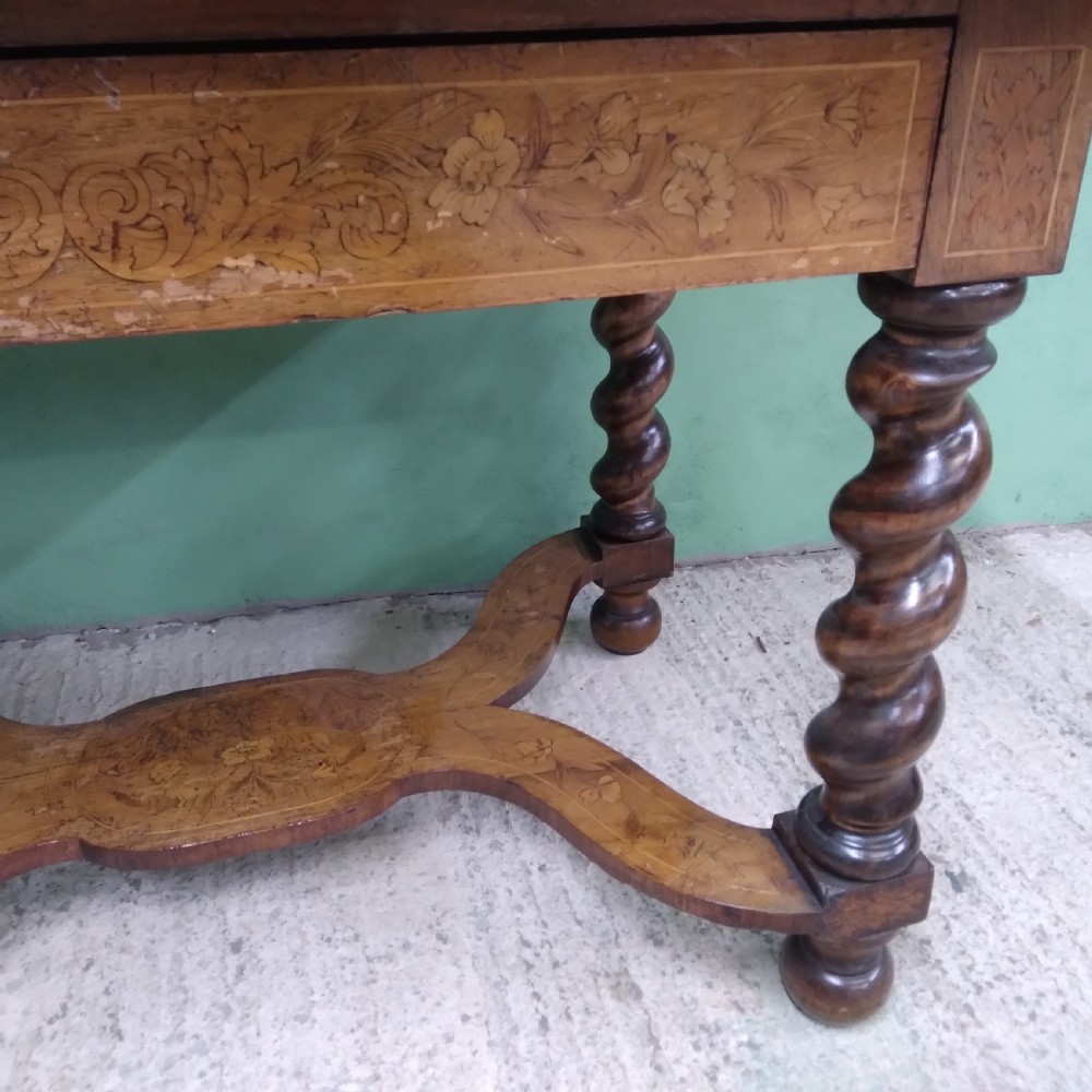 An 18th-century rectangular wooden centre table featuring elaborate floral marquetry inlay on the top, twisted legs, and a curvilinear X-frame stretcher. View IX