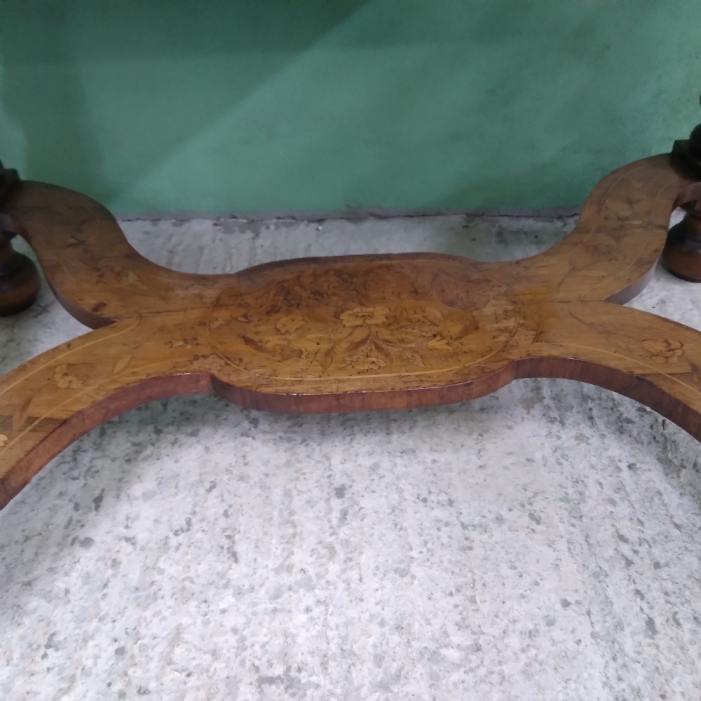 An 18th-century rectangular wooden centre table featuring elaborate floral marquetry inlay on the top, twisted legs, and a curvilinear X-frame stretcher. View X