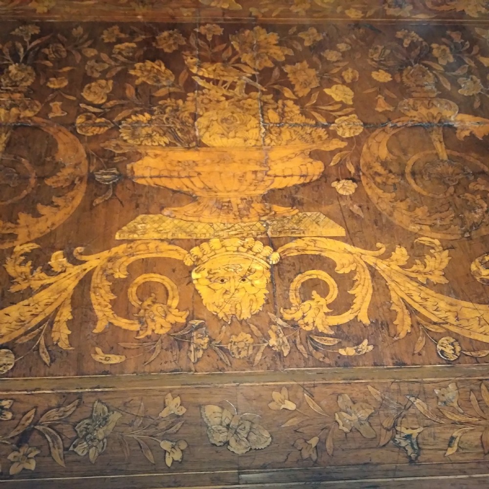An 18th-century rectangular wooden centre table featuring elaborate floral marquetry inlay on the top, twisted legs, and a curvilinear X-frame stretcher. View XV