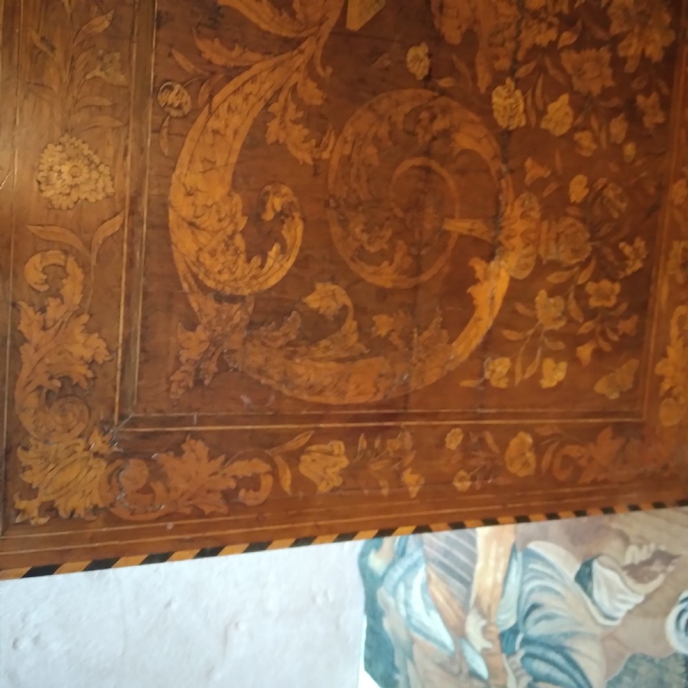 An 18th-century rectangular wooden centre table featuring elaborate floral marquetry inlay on the top, twisted legs, and a curvilinear X-frame stretcher. View XVII