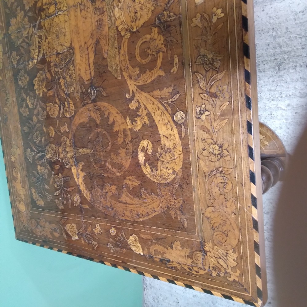 An 18th-century rectangular wooden centre table featuring elaborate floral marquetry inlay on the top, twisted legs, and a curvilinear X-frame stretcher. View XXII