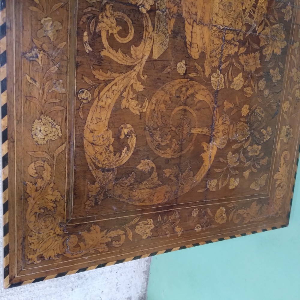 An 18th-century rectangular wooden centre table featuring elaborate floral marquetry inlay on the top, twisted legs, and a curvilinear X-frame stretcher. View XXIII