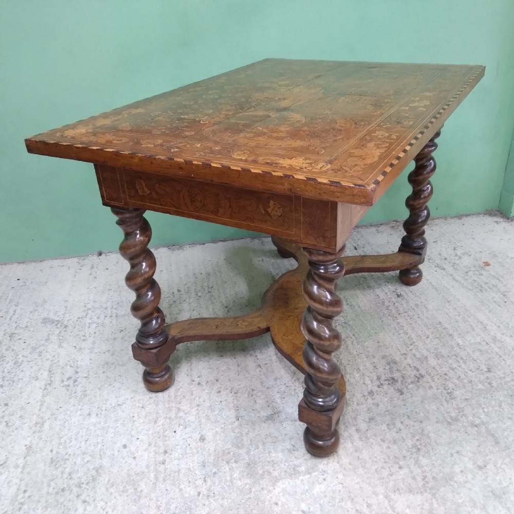 An 18th-century rectangular wooden centre table featuring elaborate floral marquetry inlay on the top, twisted legs, and a curvilinear X-frame stretcher. View XXVII