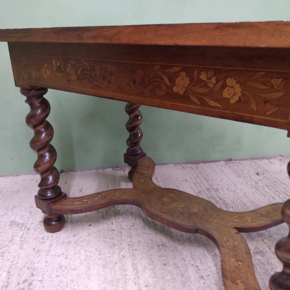 An 18th-century rectangular wooden centre table featuring elaborate floral marquetry inlay on the top, twisted legs, and a curvilinear X-frame stretcher. View XXIX