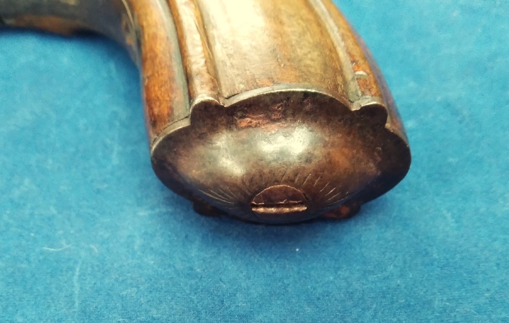 A nineteenth-century percussion cap pocket pistol with a carved walnut grip and steel barrel. View VIII