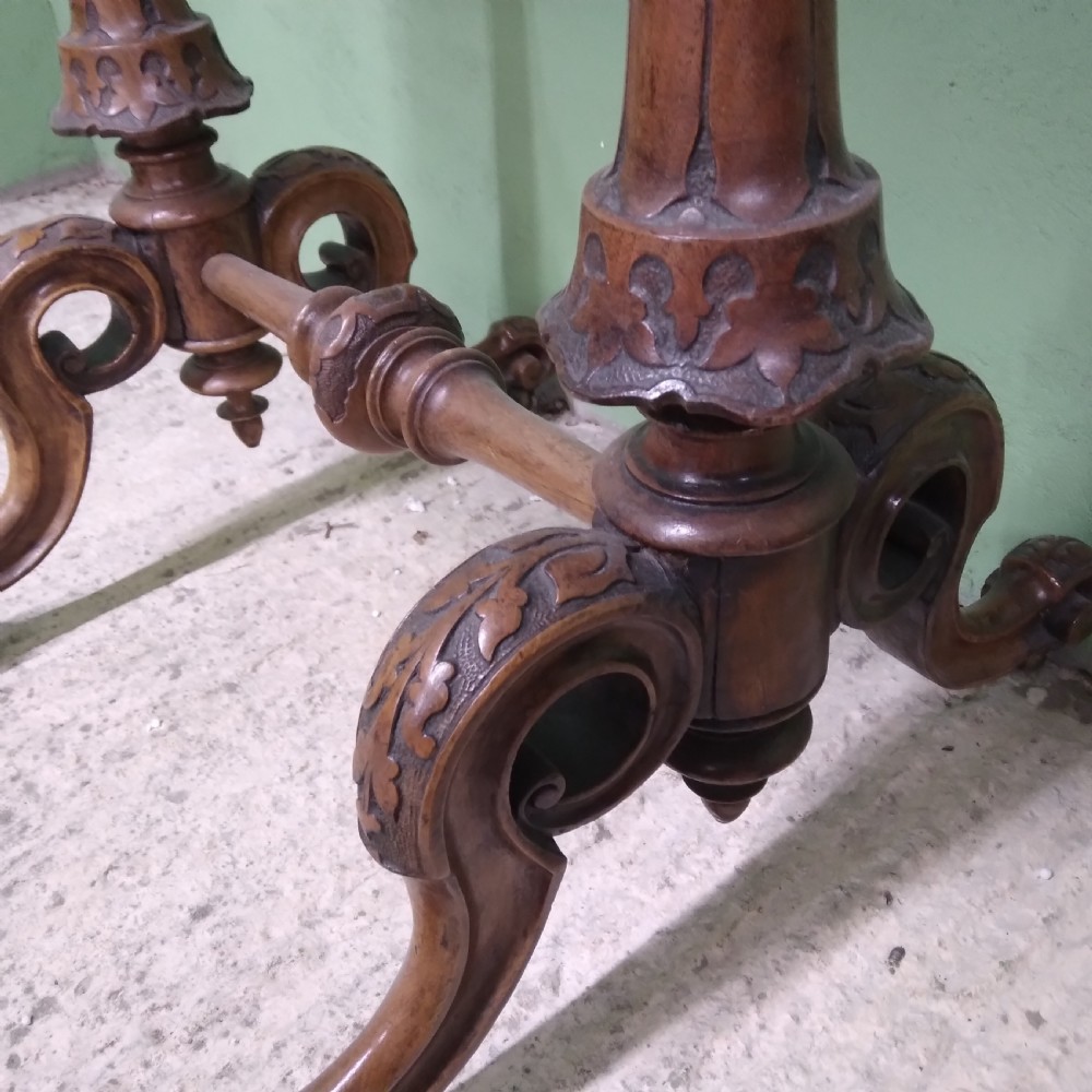 A Victorian burr walnut work table featuring a central Tunbridge ware marquetry landscape scene, serpentine edges, and turned legs with scroll feet. View V