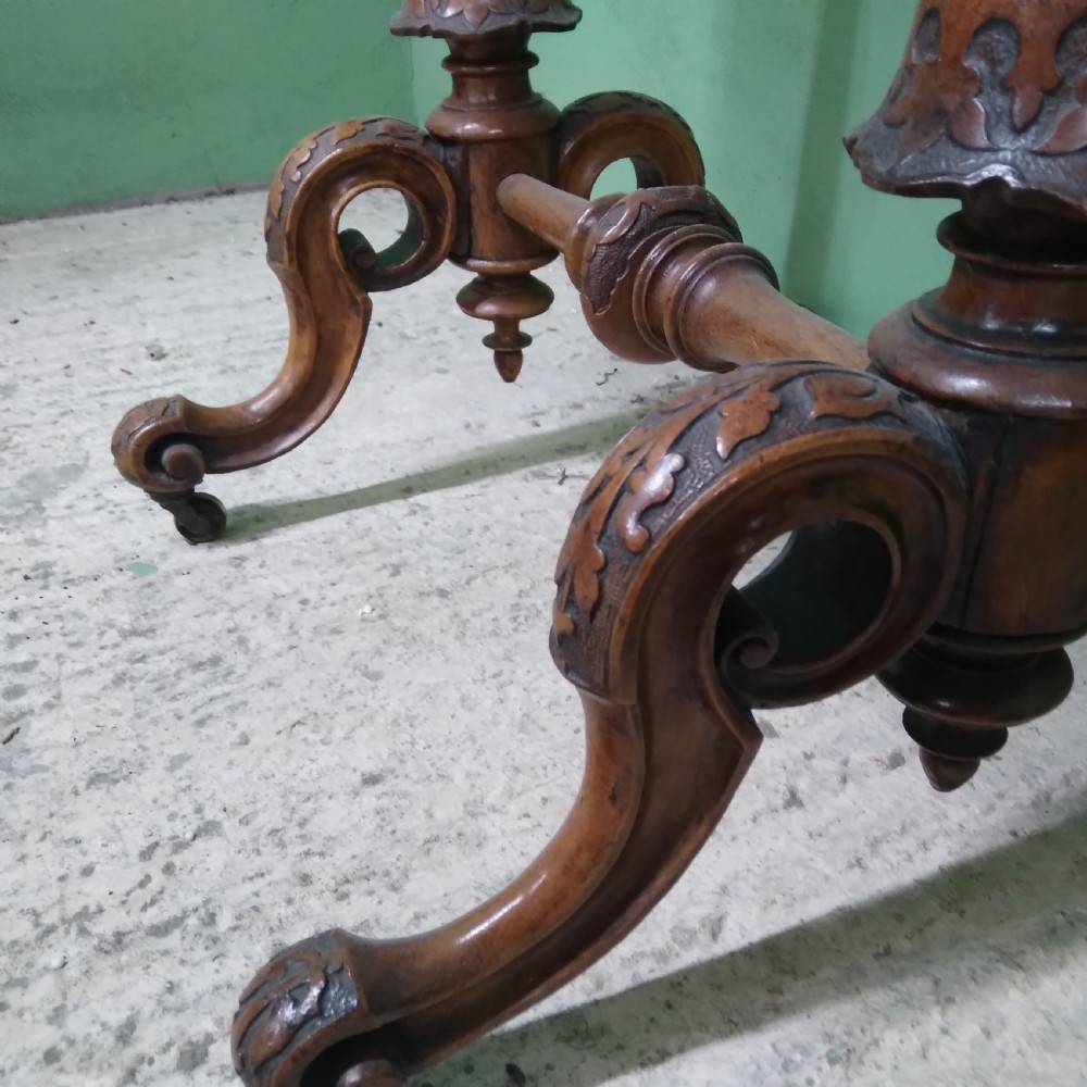 A Victorian burr walnut work table featuring a central Tunbridge ware marquetry landscape scene, serpentine edges, and turned legs with scroll feet. View VI