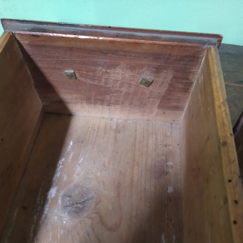 An antique fruitwood lowboy table featuring three drawers with brass drop handles, a shaped lower apron, and four square legs. View VI