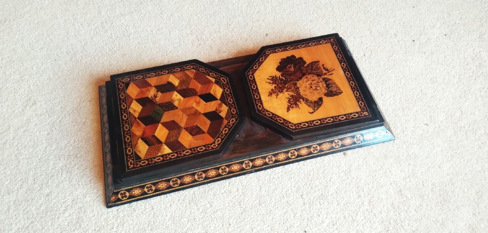 An antique wooden expanding book slide featuring detailed Tunbridge ware mosaic inlays on two folding end arches and along the base border.