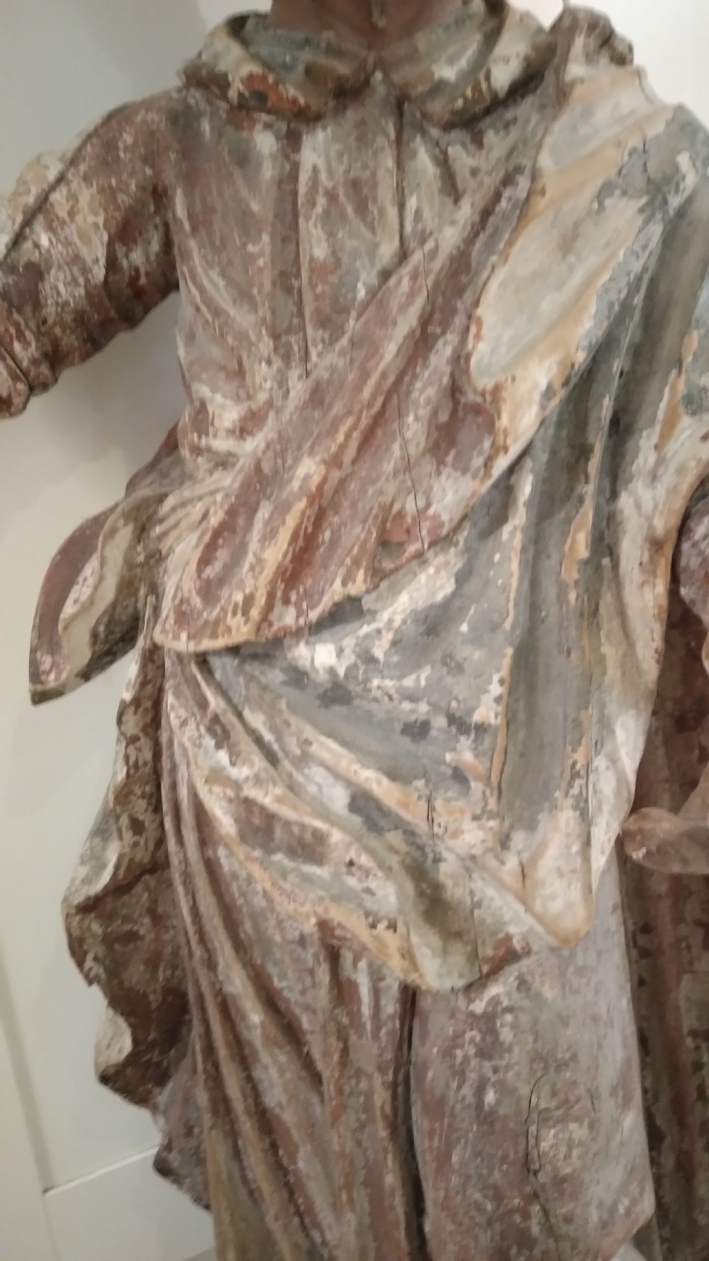 A hand-carved wooden standing figure of Saint Joseph displaying detailed drapery, a bearded face, and outstretched arms with remnants of polychrome paint. View II