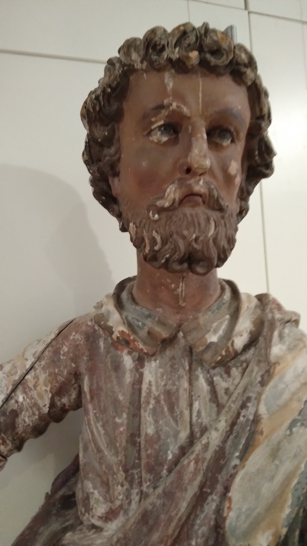 A hand-carved wooden standing figure of Saint Joseph displaying detailed drapery, a bearded face, and outstretched arms with remnants of polychrome paint. View III