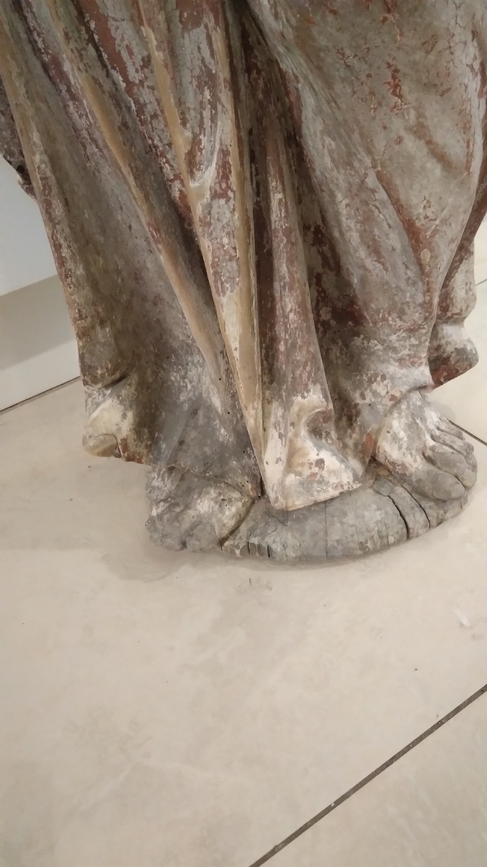 A hand-carved wooden standing figure of Saint Joseph displaying detailed drapery, a bearded face, and outstretched arms with remnants of polychrome paint. View V