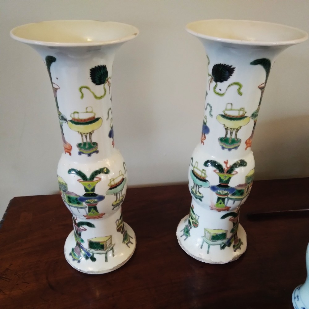 A collection of varied Chinese blue and white and polychrome porcelain vases, bowls, and jars displayed along a dark wood sideboard. View VI