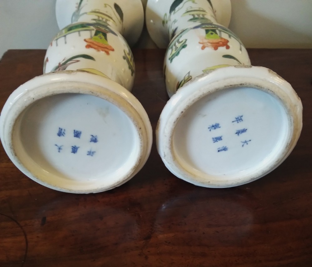 A collection of varied Chinese blue and white and polychrome porcelain vases, bowls, and jars displayed along a dark wood sideboard. View VII