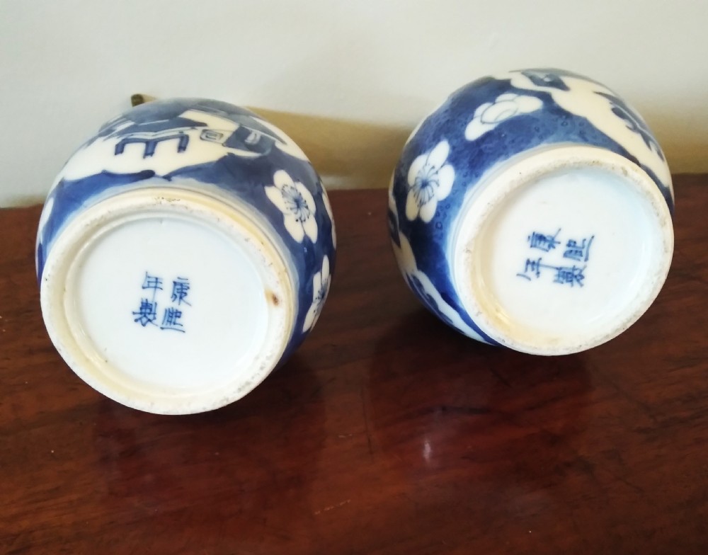 A collection of varied Chinese blue and white and polychrome porcelain vases, bowls, and jars displayed along a dark wood sideboard. View IX