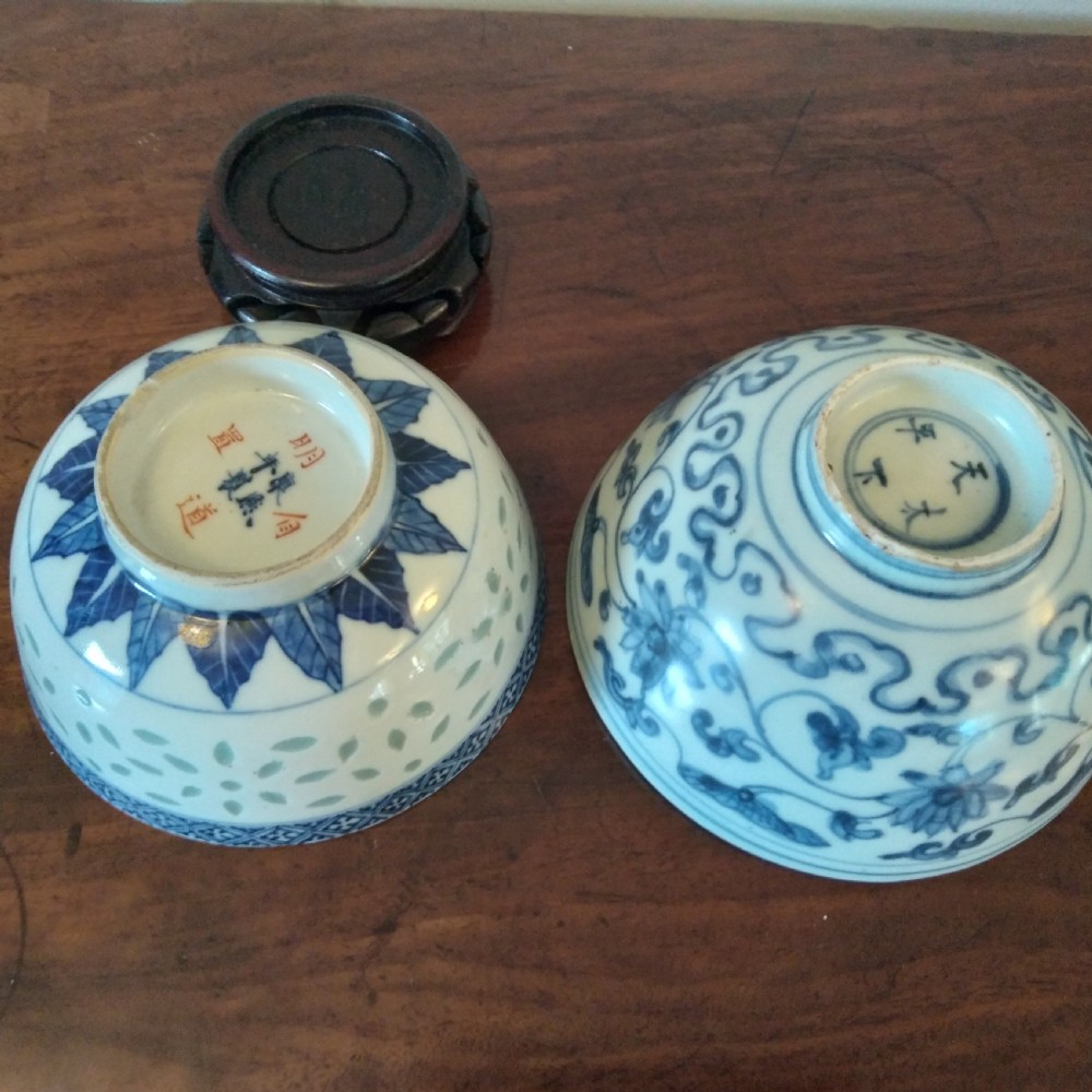 A collection of varied Chinese blue and white and polychrome porcelain vases, bowls, and jars displayed along a dark wood sideboard. View XI