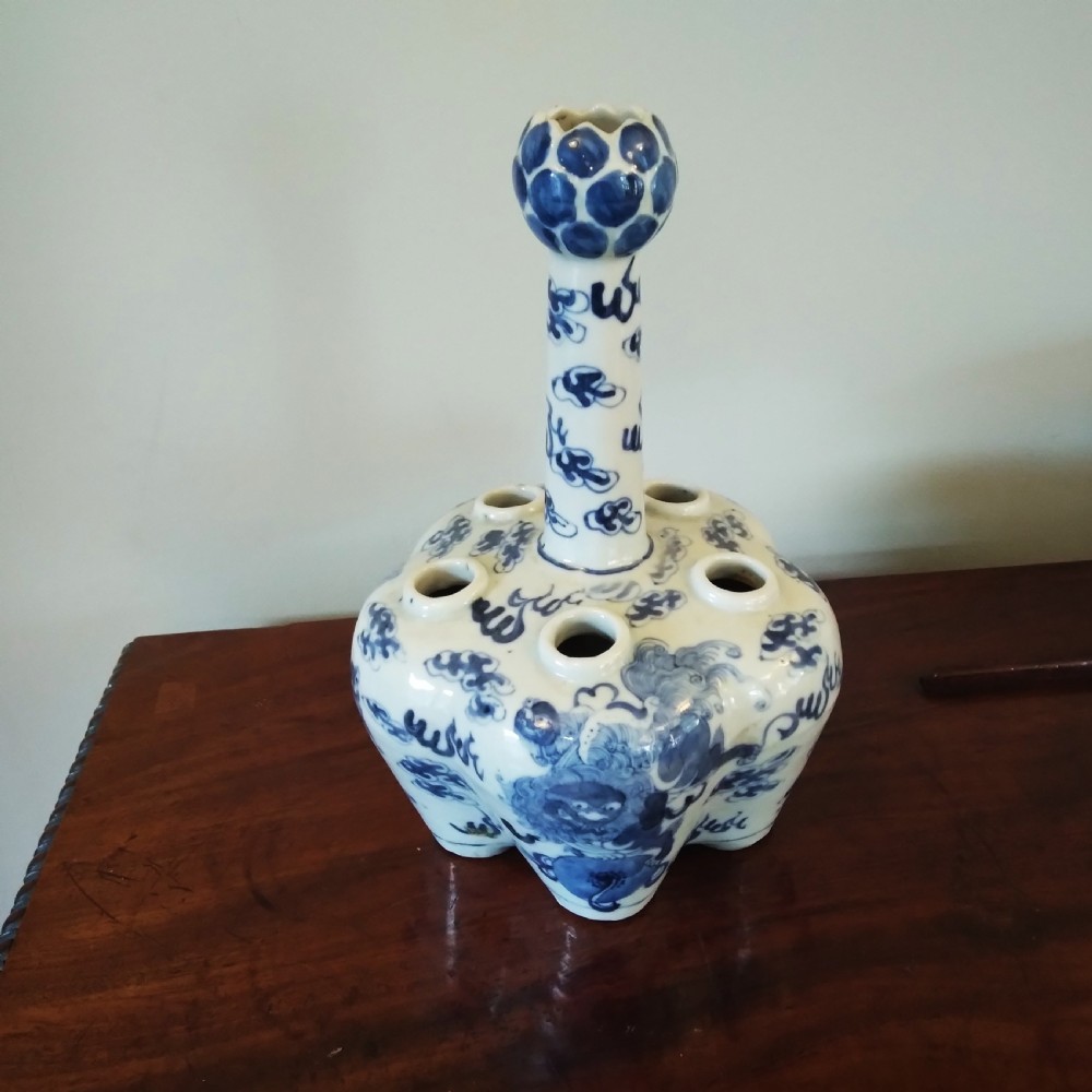 A collection of varied Chinese blue and white and polychrome porcelain vases, bowls, and jars displayed along a dark wood sideboard. View XII