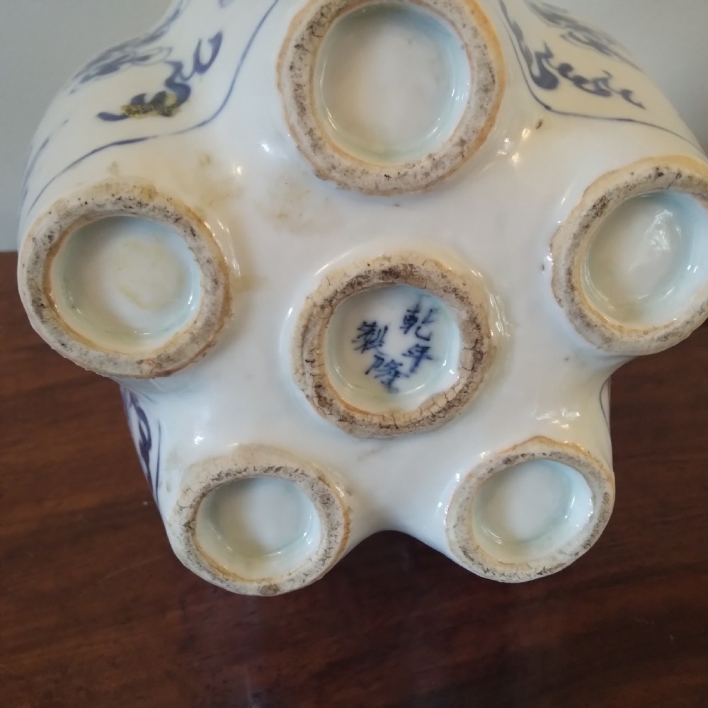 A collection of varied Chinese blue and white and polychrome porcelain vases, bowls, and jars displayed along a dark wood sideboard. View XIII