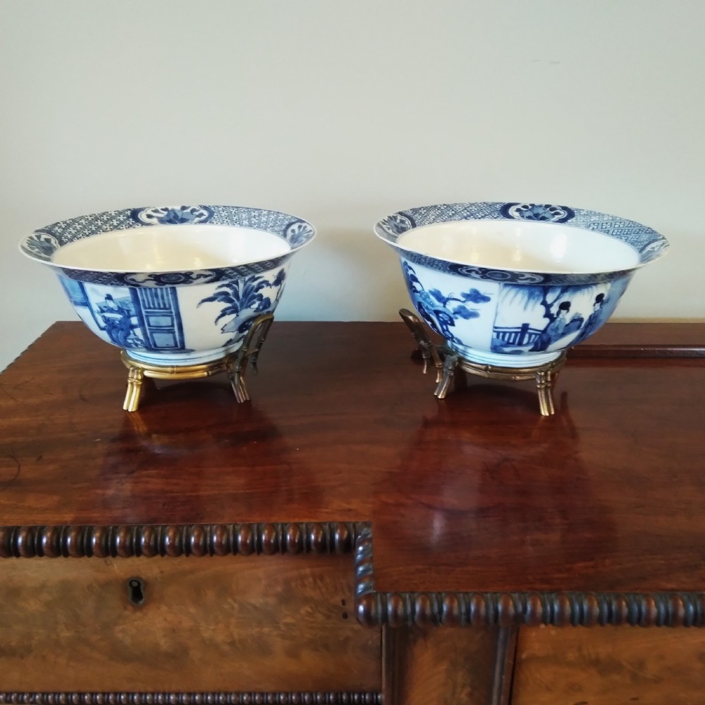 A collection of varied Chinese blue and white and polychrome porcelain vases, bowls, and jars displayed along a dark wood sideboard. View XIV