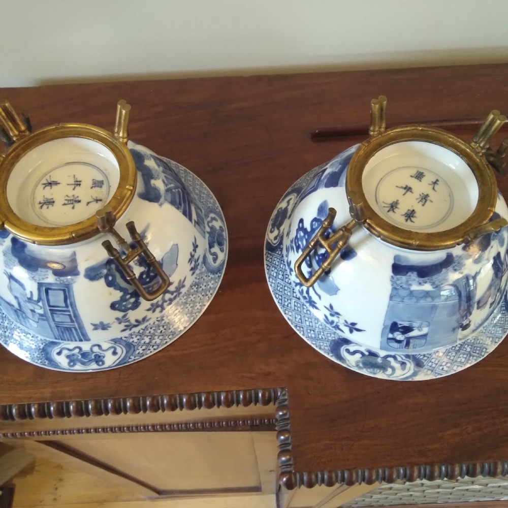 A collection of varied Chinese blue and white and polychrome porcelain vases, bowls, and jars displayed along a dark wood sideboard. View XV