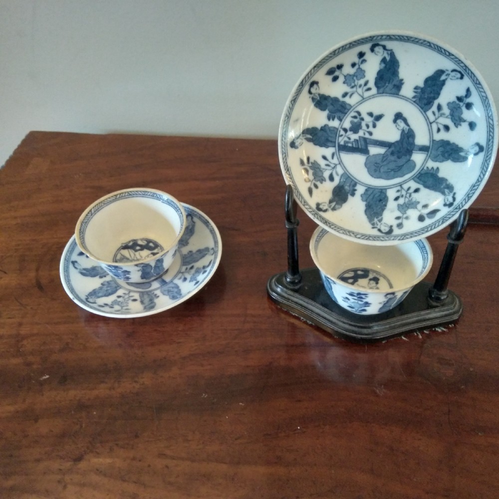 A collection of varied Chinese blue and white and polychrome porcelain vases, bowls, and jars displayed along a dark wood sideboard. View XVI
